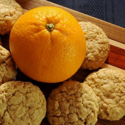 an orange surround by cookie placed on cutting board