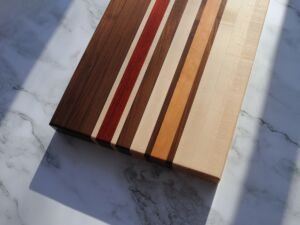 Edge grain cutting board made from walnut, maple, cherry, and padauk